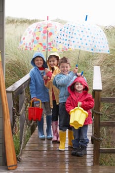 Children posing with umbrella