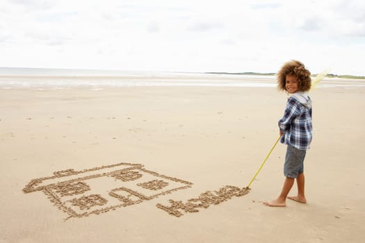 Boy drawing in sand