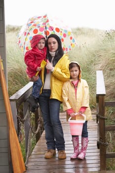 Sad mother and children on beach