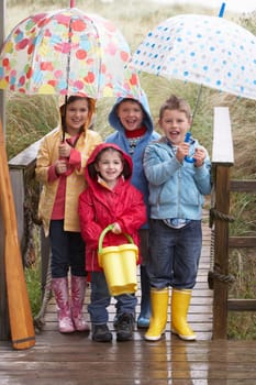Children posing with umbrella