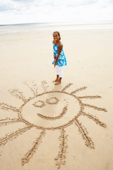 Girl drawing in sand