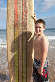 Teenage boy with surfboard
