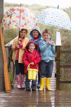 Children posing with umbrella