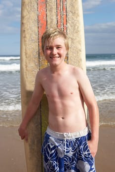 Teenage boy with surfboard