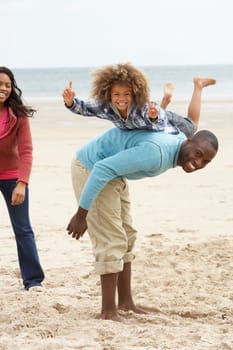 Happy family playing on beach