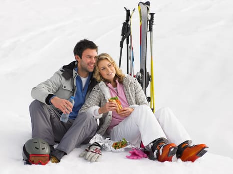 Young Couple With Picnic On Ski Vacation