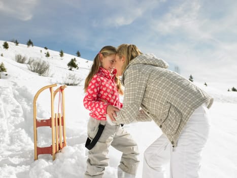 Young Mother And Daughter On Winter Vacation