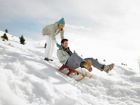 Young Couple Sledding