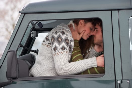 Young couple in car in snow