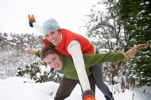 Young couple having fun in snow