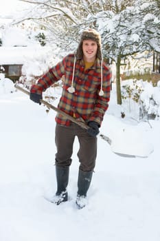 Young man clearing snow