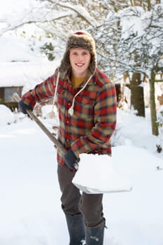 Young man clearing snow