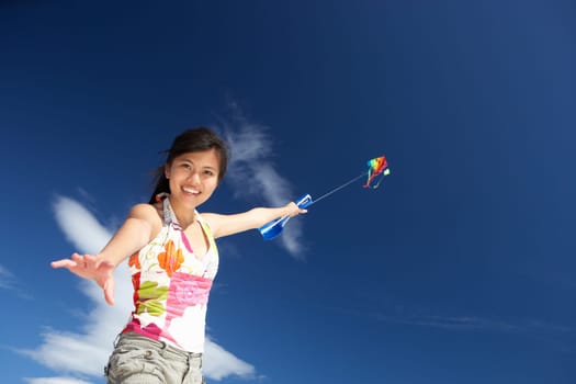Teenage girl flying a kite