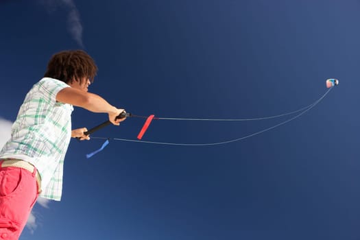 Teenage boy flying a kite