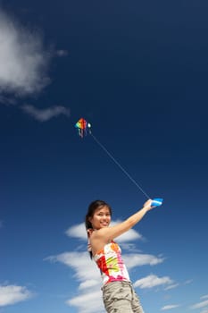 Teenage girl flying a kite