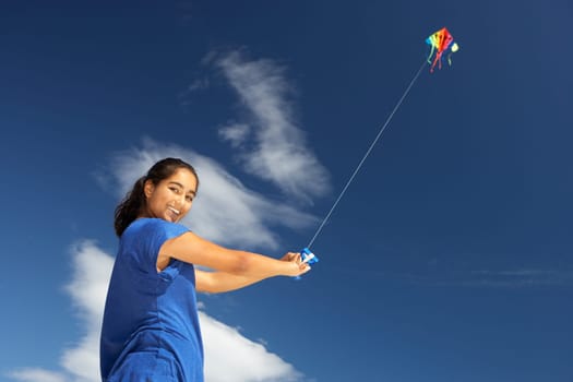 Teenage girl flying a kite