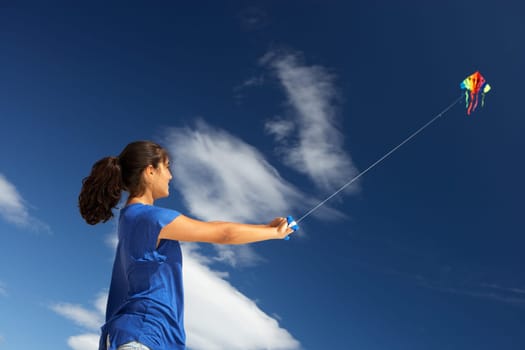 Teenage girl flying a kite