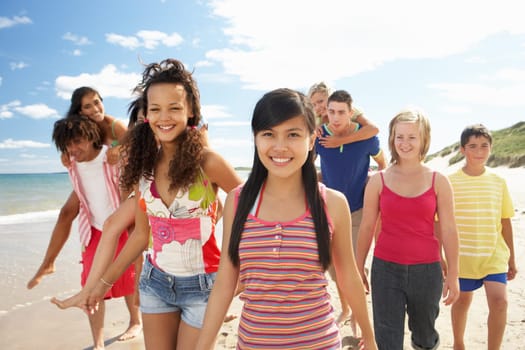 Teenagers walking on beach