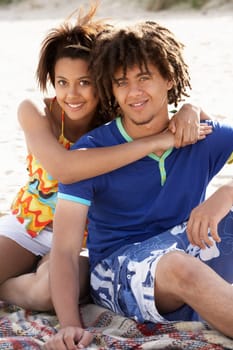 Portrait teenage couple on beach