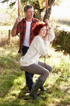 Couple with country garden swing
