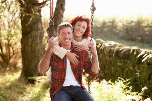 Couple with country garden swing