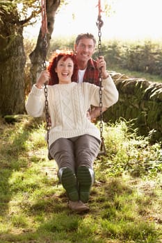 Couple with country garden swing