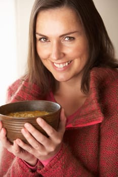 Woman holding bowl of soup