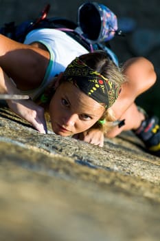 Vertical image of girl training rock-climbing