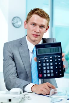 Portrait of a successful employer with calculator looking at camera