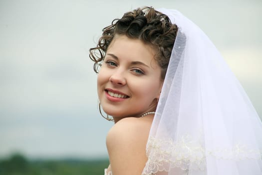 Portrait of happy bride looking at camera with smile