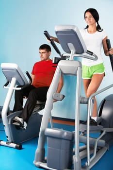 Image of beautiful girl on training apparatus in sport club