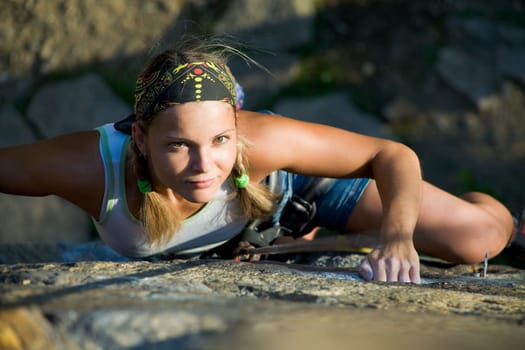 Image of blonde lady climbing on the rock