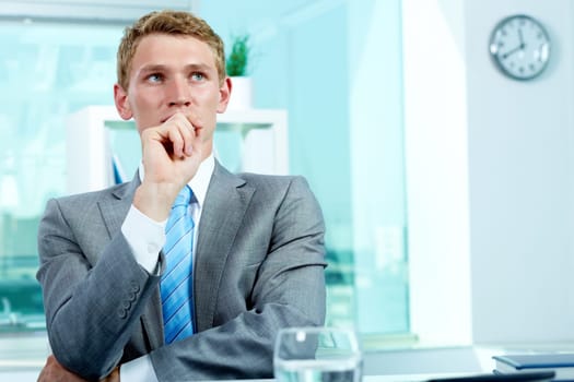 Portrait of a pensive businessman with hand by his mouth