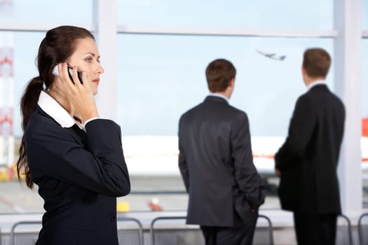 Image of businesswoman calling by phone in the airport