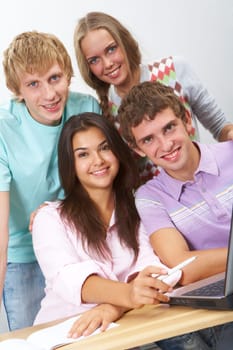 Portrait of happy teens looking at camera with smiles in classroom