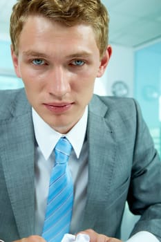 Portrait of tired businessman looking at camera