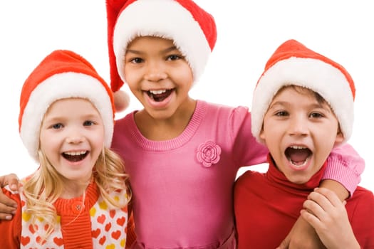 Photo of happy friends in Santa caps laughing over white background