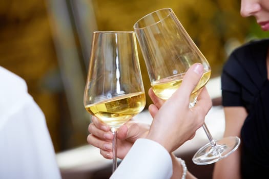 Close-up of couple hands holding champagne flutes during celebration