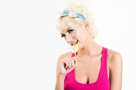 Portrait of funny girl nibbling candy on a white background