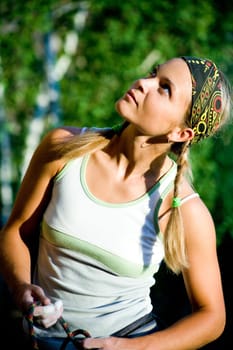 Image of young girl looking in aside on the background of trees
