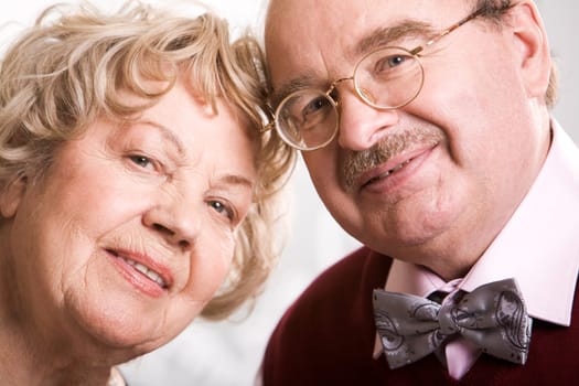 Two smart elderly people looking at camera during their jubilee