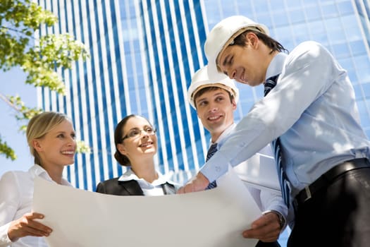 Image of group of several workers planning their work outside