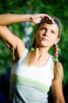 Portrait of young lady in t-shirt and head bandage looking in aside