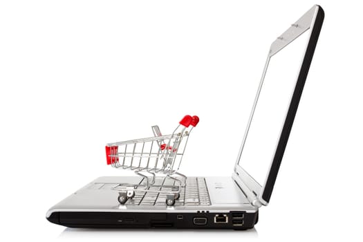laptop with shopping cart over a white background