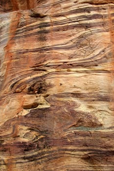 Surface of red sandstone rock with wavy grains