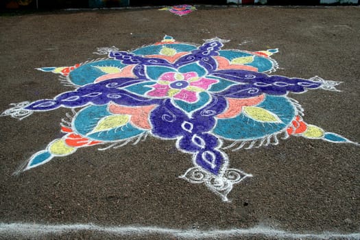 Skillful rangoli handiwork design using coloured stone powder