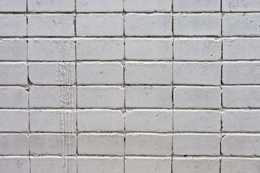 white roughly textured brick wall painted with white paint