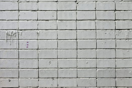 white roughly textured brick wall painted with white paint