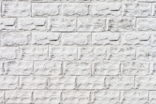 white roughly textured brick wall painted with white paint