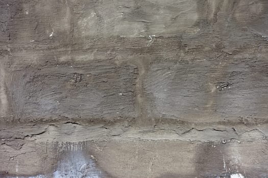 white roughly textured brick wall painted with white paint